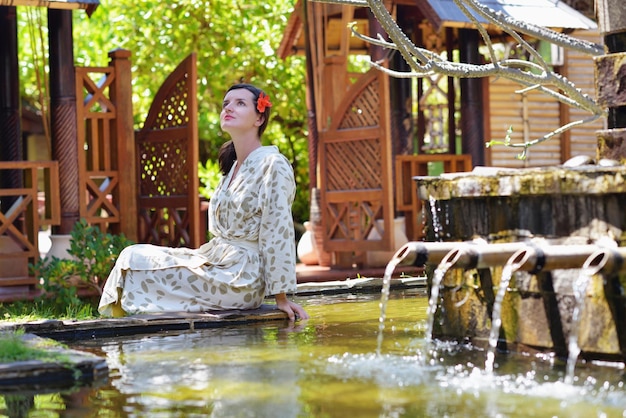 Woman getting spa treatment at tropical resort