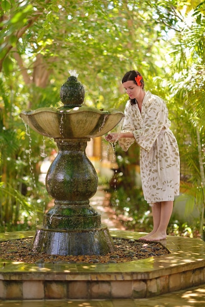 Woman getting spa treatment at tropical resort