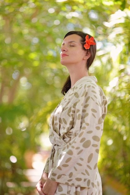 Woman getting spa treatment at tropical resort