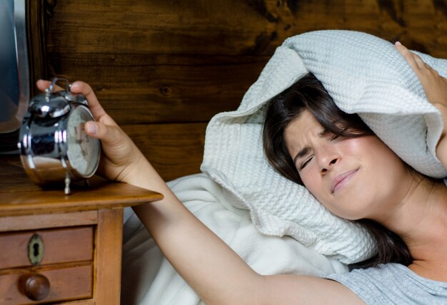 Woman getting stressed about waking up early