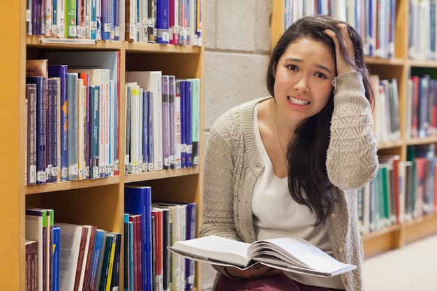 Woman getting stressed on library floor