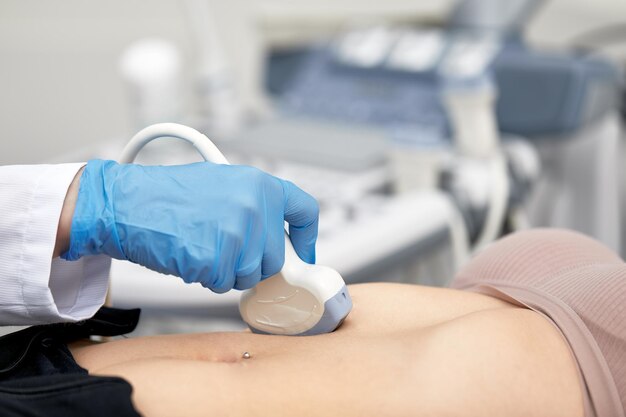 Woman getting ultrasound of a thyroid from doctor