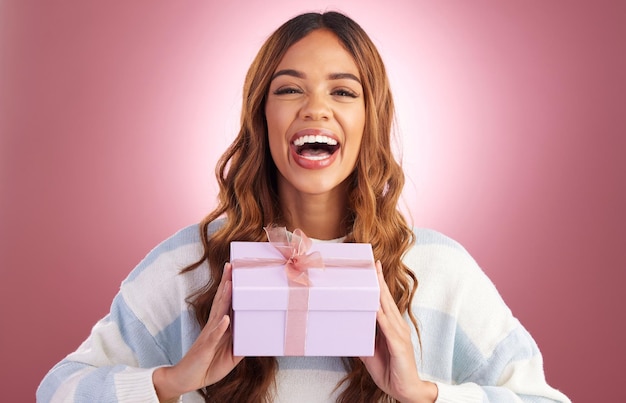 Woman gift and box in studio portrait with happiness surprise and celebration by gradient background Student girl young and happy with present package excited face and celebrate for birthday