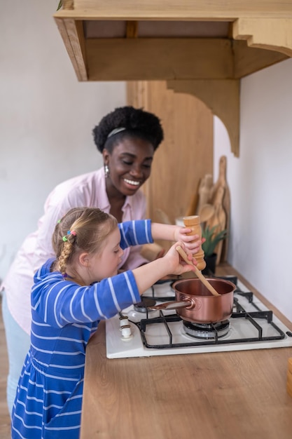 A woman and a girl looking busy while doing some housework