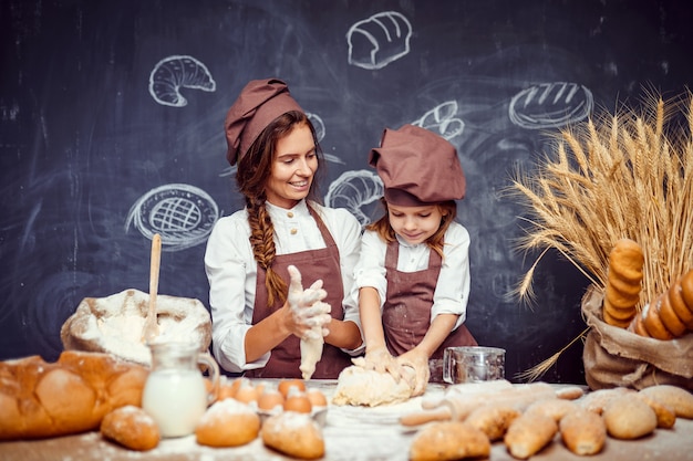 Woman and girl making pastries together
