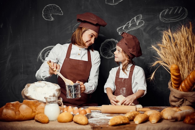 Woman and girl making pastries together