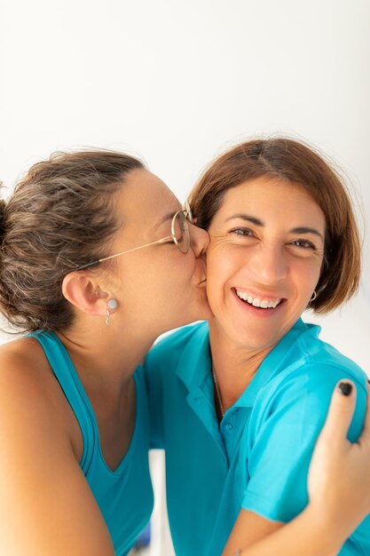 A woman gives a kiss to her physiotherapist friend after receiving a massage at the physiotherapy clinic