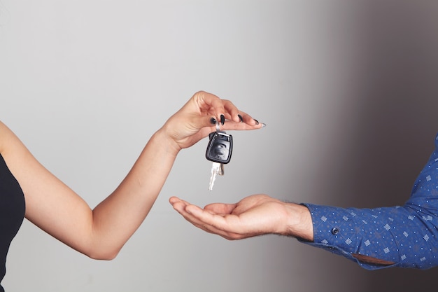 The woman gives the man the car keys