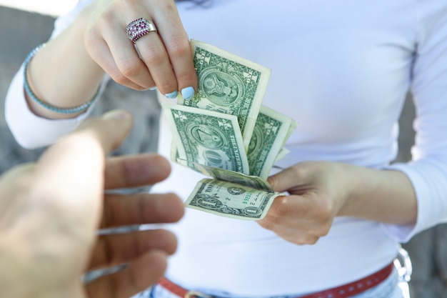 Woman gives money on the street