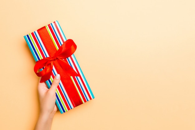 Woman gives Valentine gift box with red bow