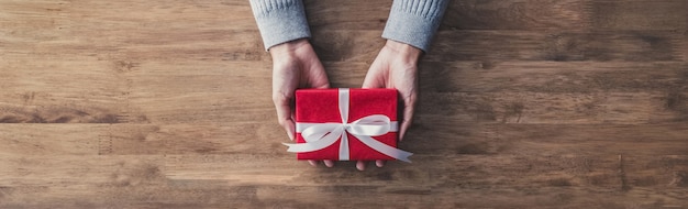 Woman giving a christmas or birthday gift - web banner