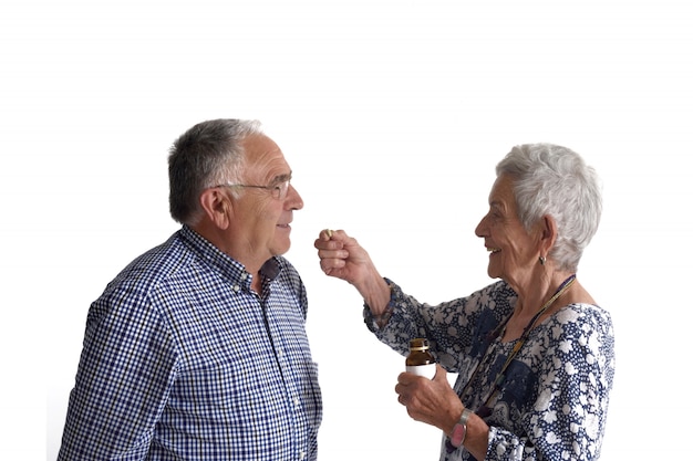 A woman giving her partner medication