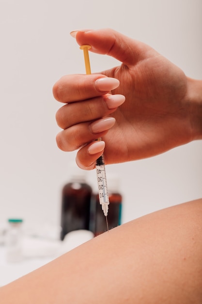 Woman giving herself an injection against diabetes