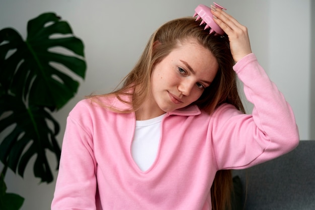 Woman giving herself scalp massage