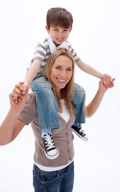 Woman giving little boy piggyback ride