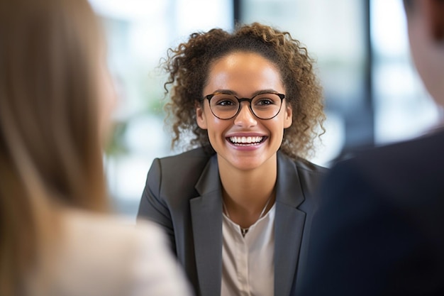 a woman in glasses smiles at a presentation.