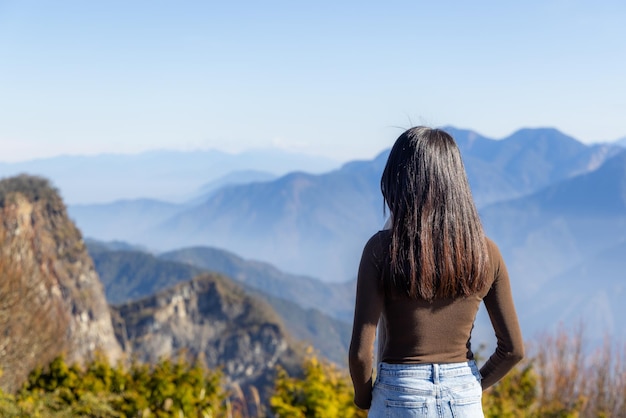 Woman go hiking and enjoy the scenery view on the mountain