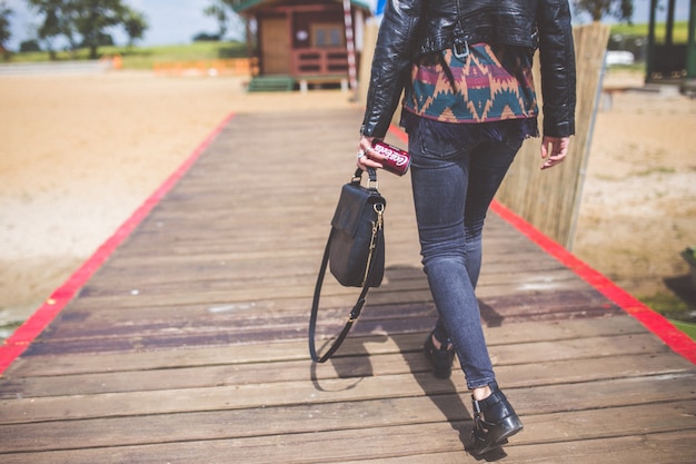 a woman goes to the beach with a bridge