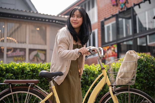 A woman going to a supermarket with her bicycle A female traveller exploring the city with a bike