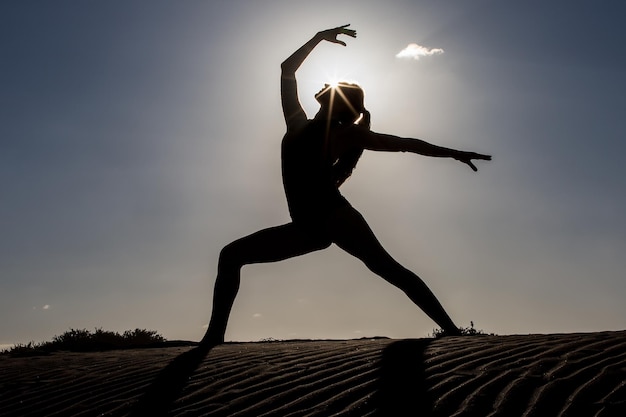 Woman in graceful asana against sunshine