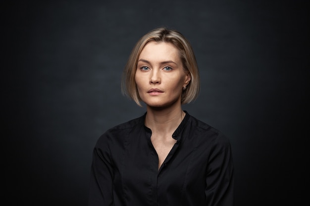 woman on gray background in a black blouse