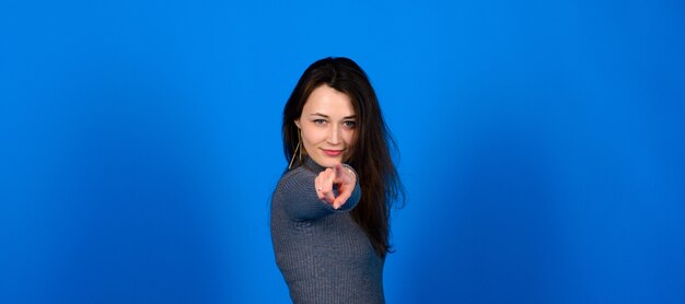 Woman in grey dress on blue background