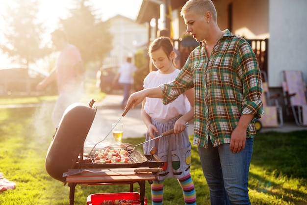 Woman grilling in backyard.