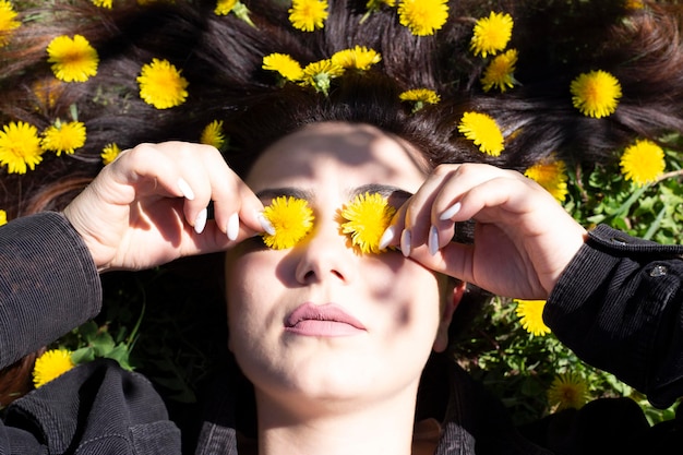 woman on ground dandelion meadow