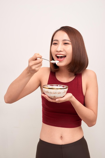 Woman in gym eating healthy after exercise