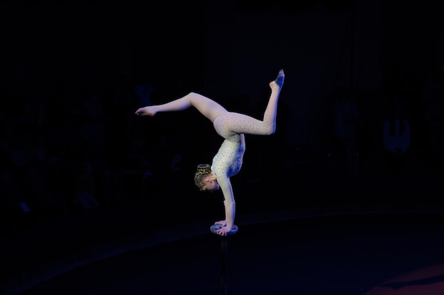 Woman gymnast performs at an acrobatic show