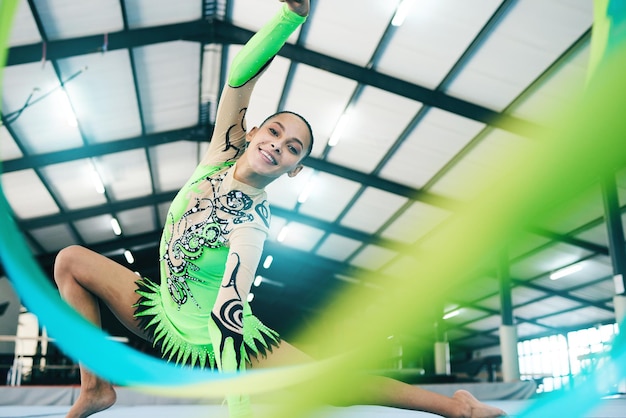 Photo woman gymnastics and ribbon portrait in performance training creative exercise or fitness practice for dynamic art smile happy and rhythmic gymnast athlete or equipment in dance sports workout