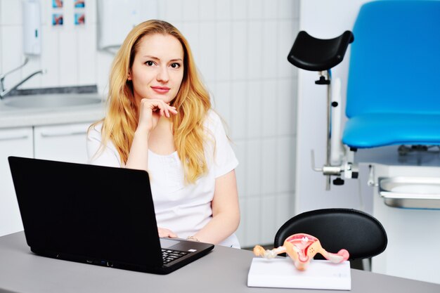 woman gynecologist at the workplace with a laptop