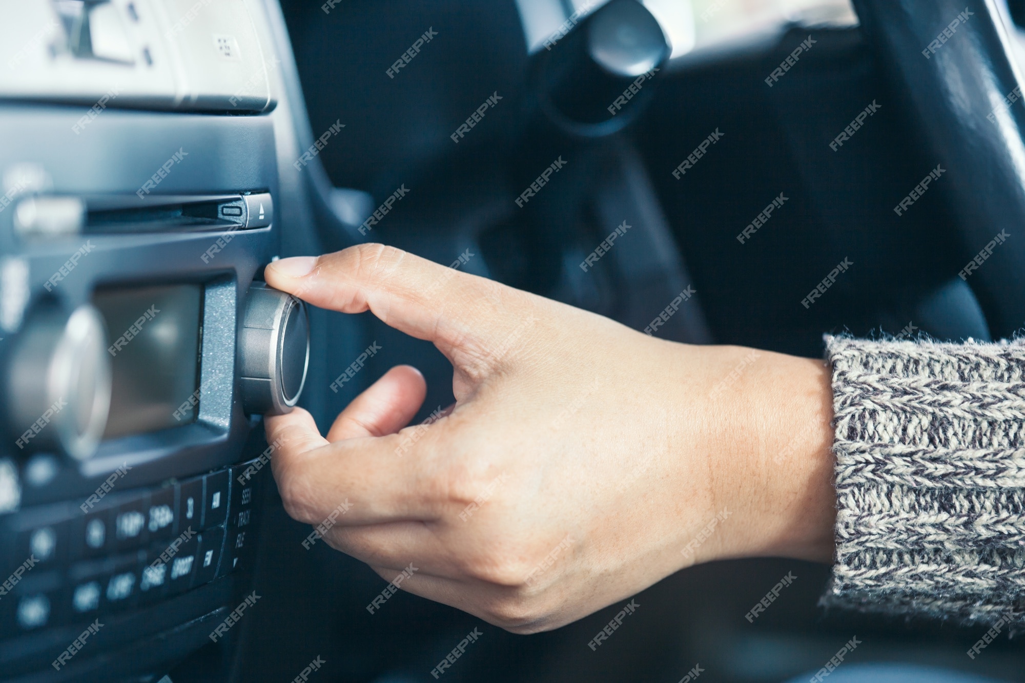 Woman Turning Up The Volume On The Car Radio Stock Photo