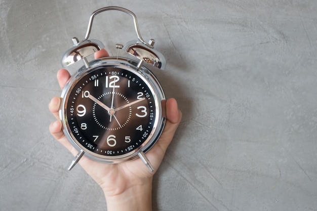 Woman Hand On Alarm Clock