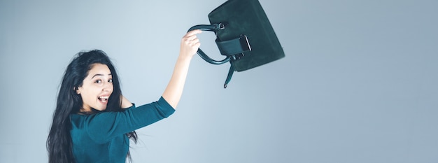 Woman hand bag in back on gray background