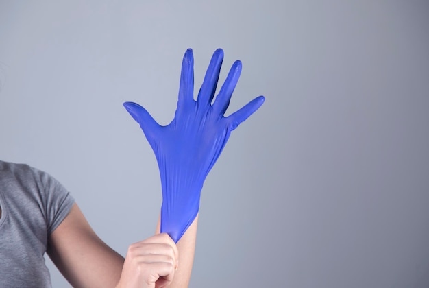 Woman hand blue glove