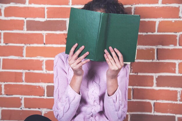 Woman hand book on face