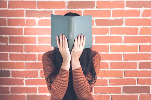 Woman hand book on face