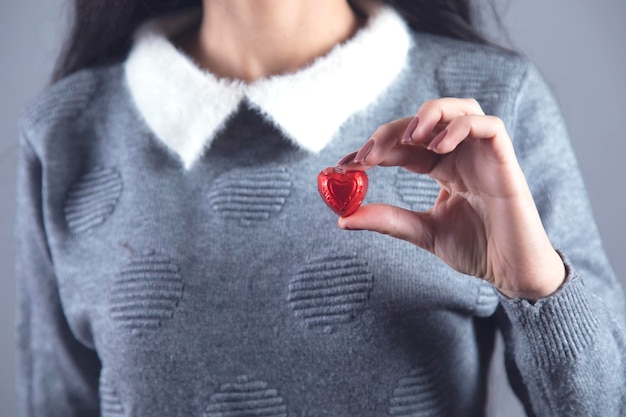 Woman hand candies heart