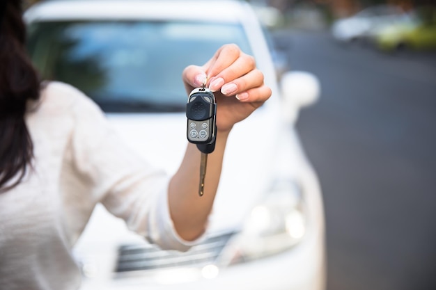 Woman hand car key in the streetxA