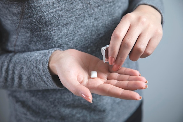 Woman hand chewing gum