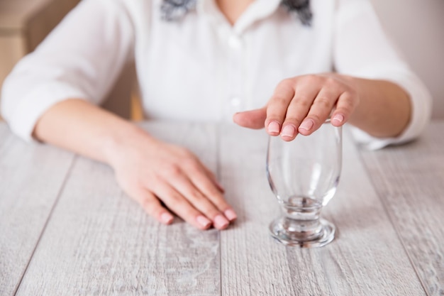 Woman hand close the empty glass