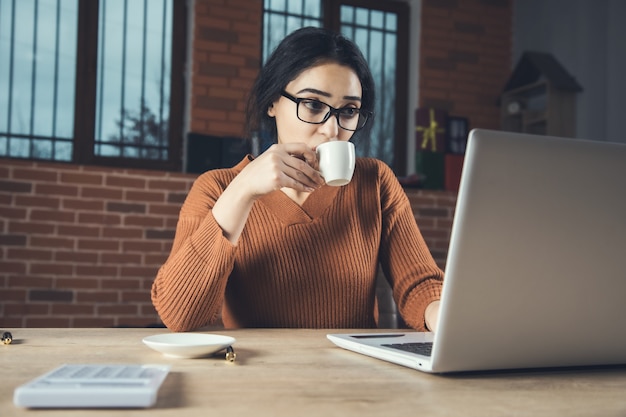 Woman hand coffee in office desk