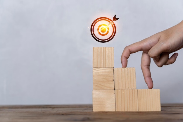 Woman hand finger walk on stacked wooden block like stairs business development and growth concept