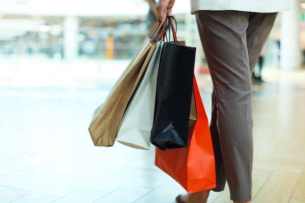 Woman hand hold shopping bag at clothes store.