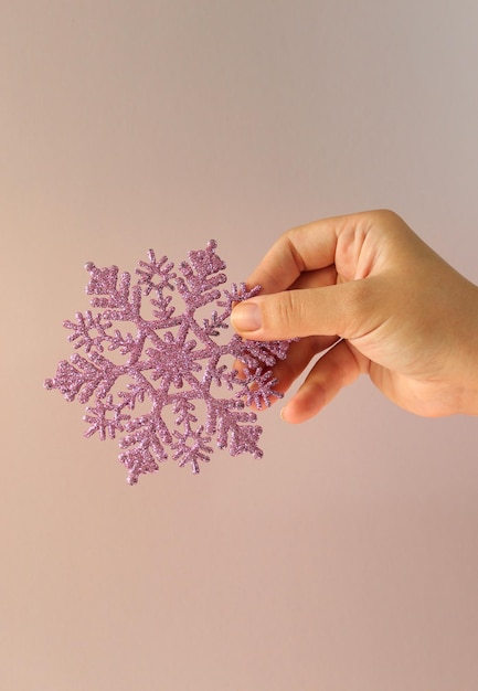 Woman hand holding big holiday snowflake