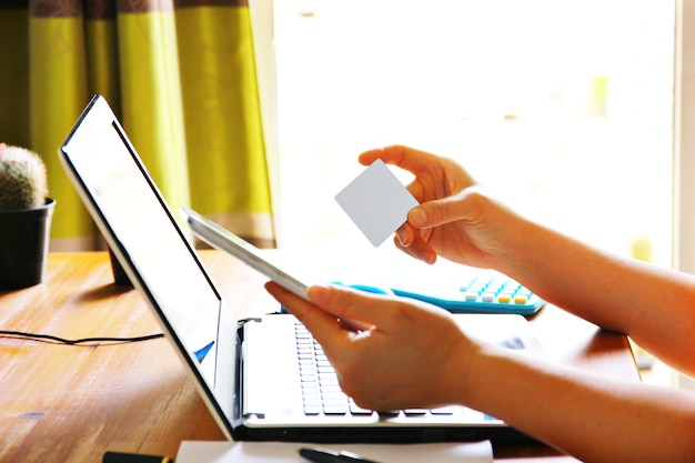 Photo woman hand holding blank gray card paying while shopping on line