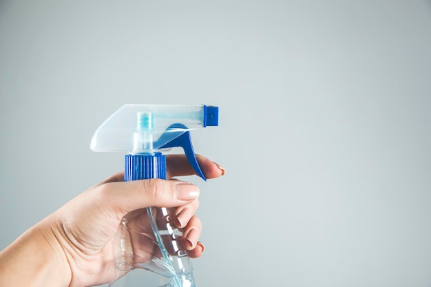 Woman hand holding cleaning fluid