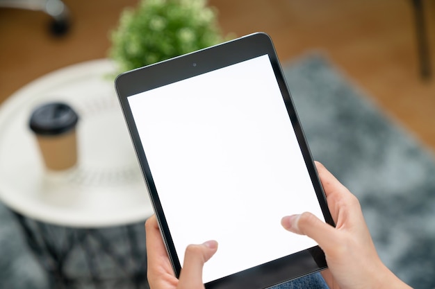 Woman hand holding digital tablet and the screen is blank