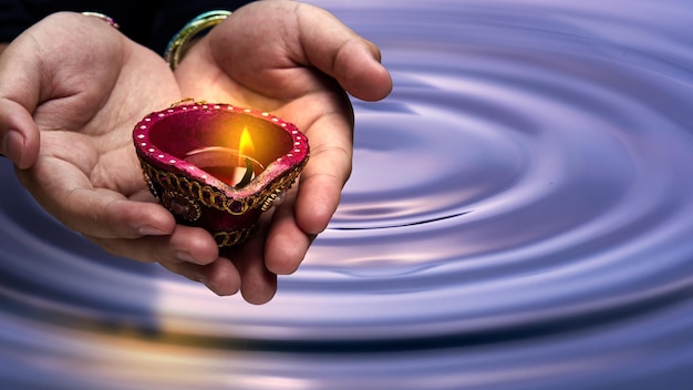 Woman hand holding Diya oil lamps for the Diwali festival Diwali Festival The Hindu Festival of Lights celebration